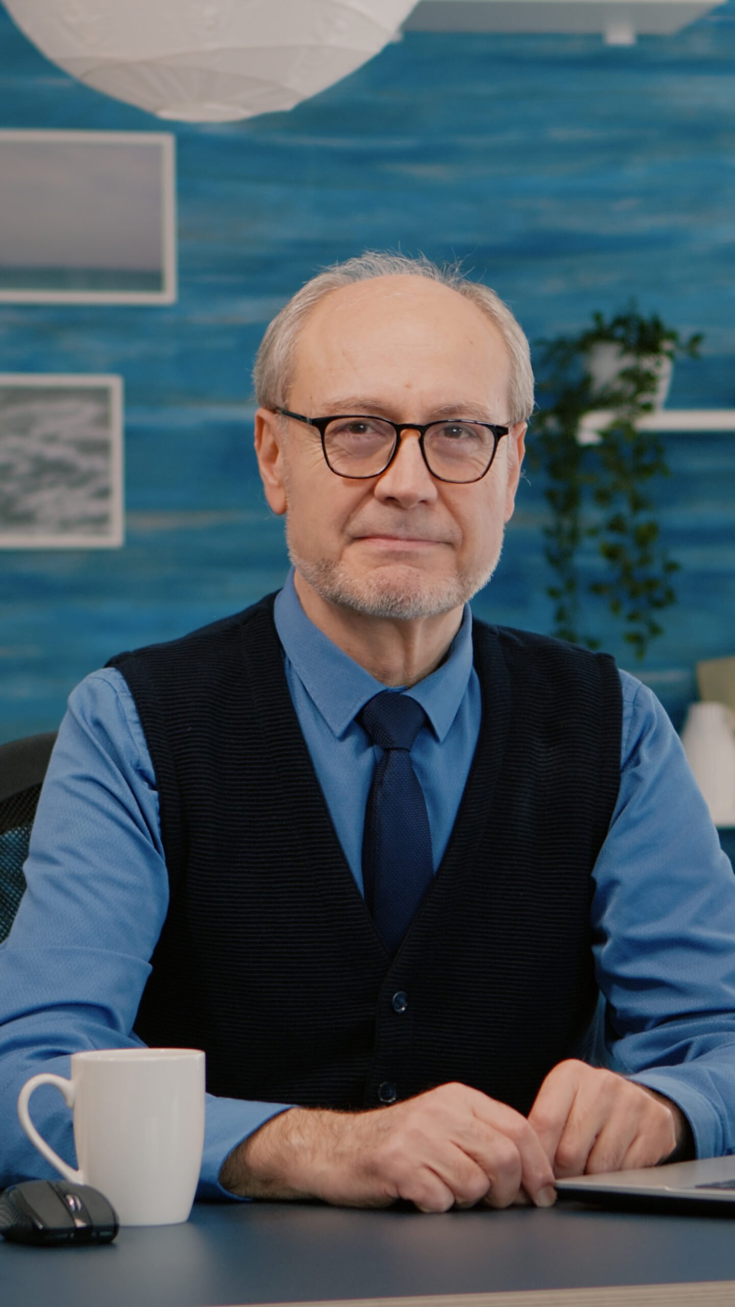 elderly businessman entrepreneur sitting workspace looking camera